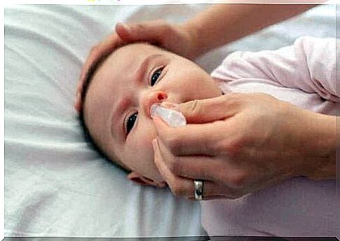 A baby getting a nasal rinse