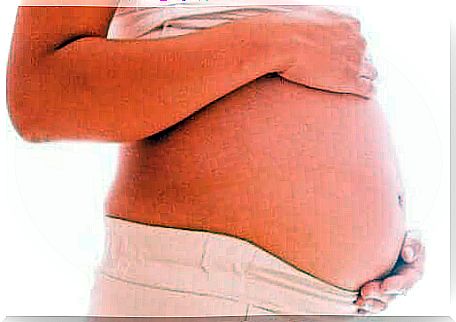 A woman holding her pregnant belly