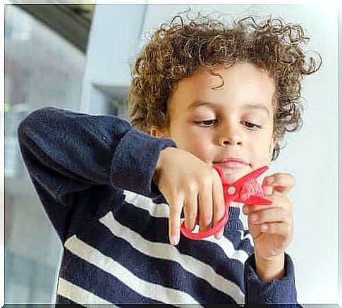 Boy with children's scissors