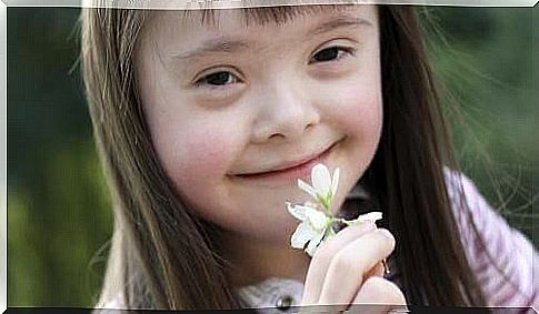 girl smells white flower