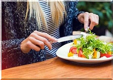 woman eats a vegetarian dish